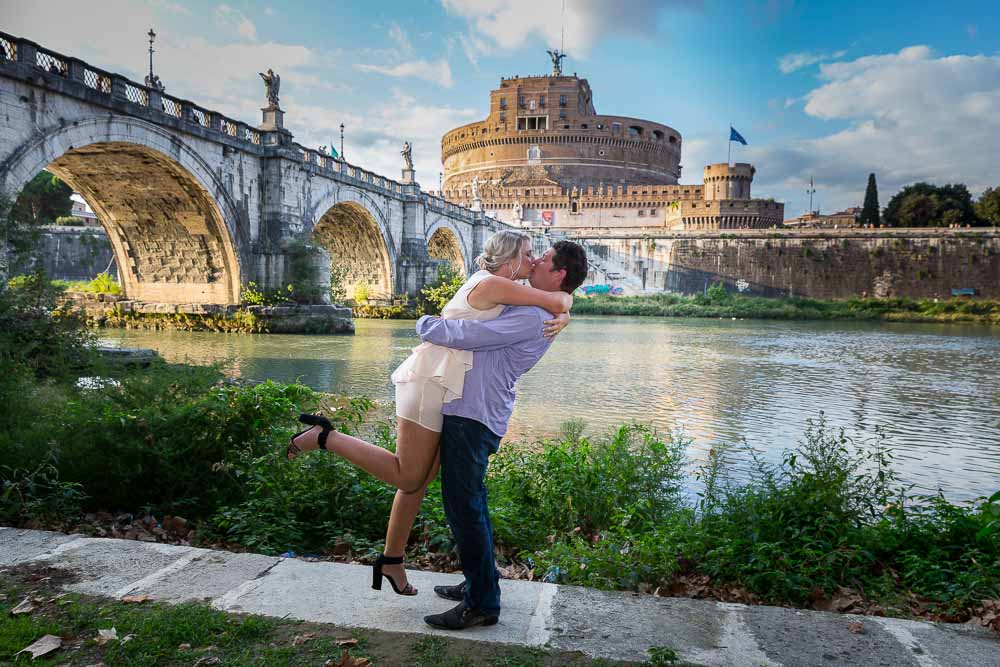 Jumping for joy at the Castel Sant'Angelo Tiber river bank in Rome Italy 