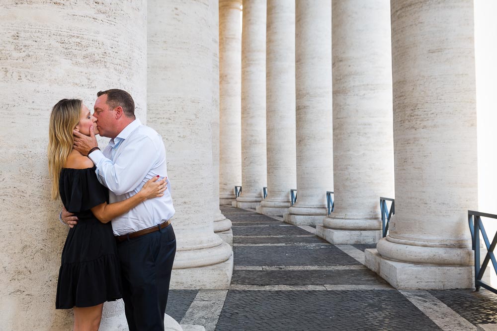 Couple kissing under the columns in St. Peter square