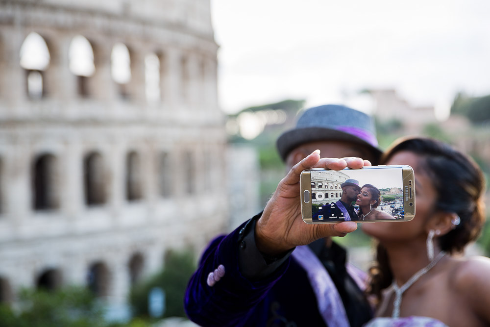Image taken of the mobile screen while romantically kissing with the Colosseum in the background