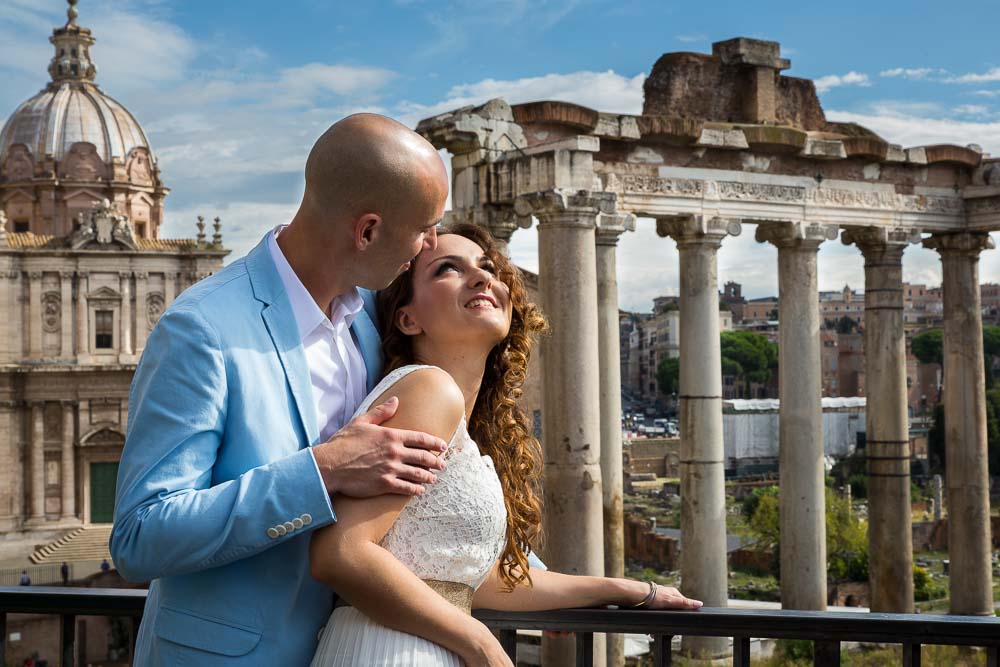 The columns of a temple used as background for a bride and groom wedding photo session at the Roman Forum