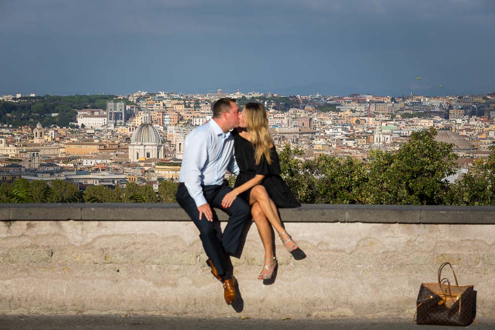 Kissing in front of the roman city at sunset