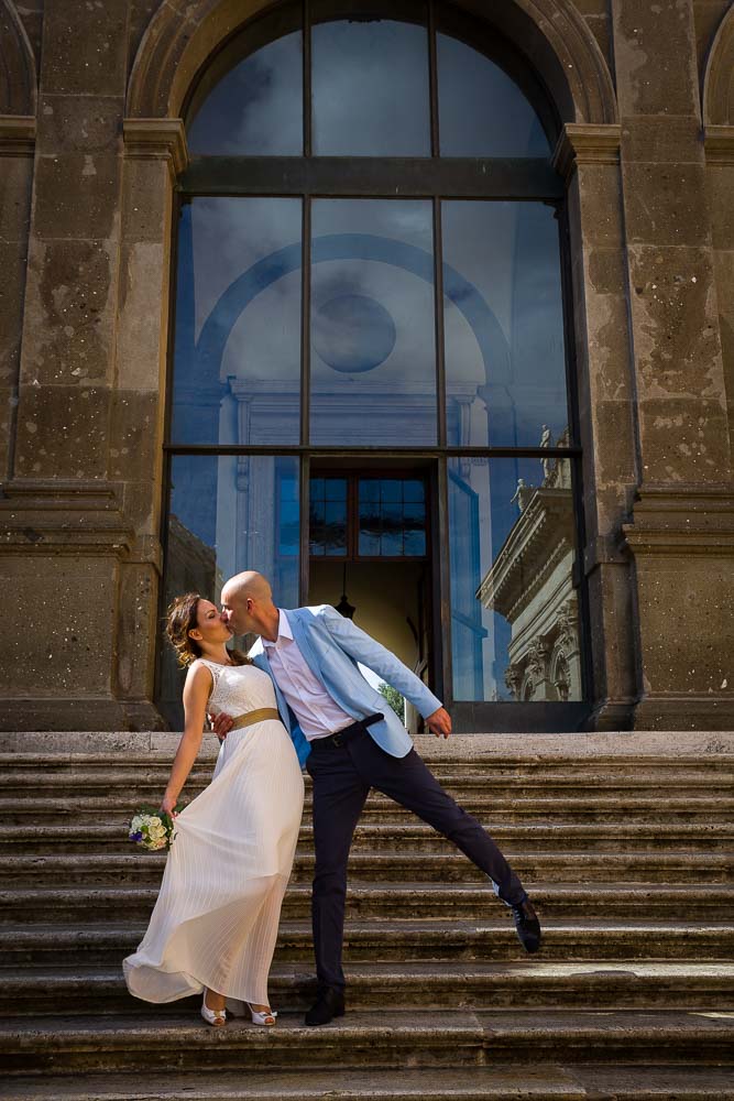 Kissing on the stairs of Piazza del Campidoglio before getting married