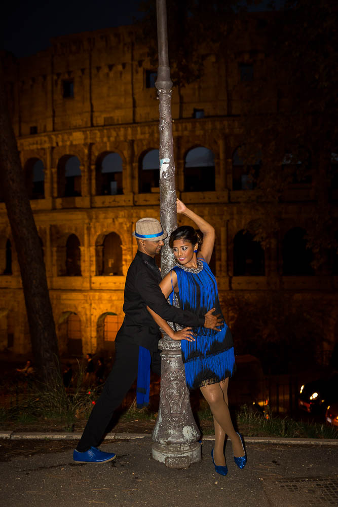 Night time photo e-session of a couple at the Roman Coliseum. Rome, Italy.