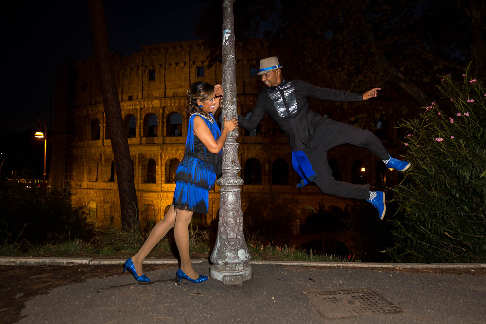 Jumping up in the air photo shoot night time session at the Colosseum in Rome