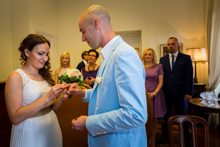 Bride and groom exchange the wedding rings