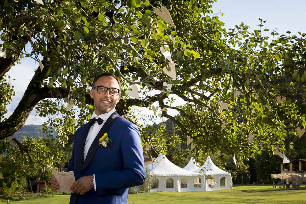 The groom looking at the bride as she walks in