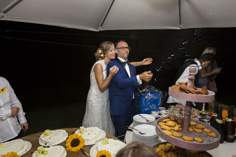 Opening up a sparking wine to celebrate a Wedding in Tuscany Italy