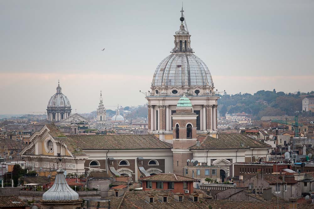 The view over the Roman city from Parco del Pincio in Rome Italy. Skyline rooftop sweeping view.