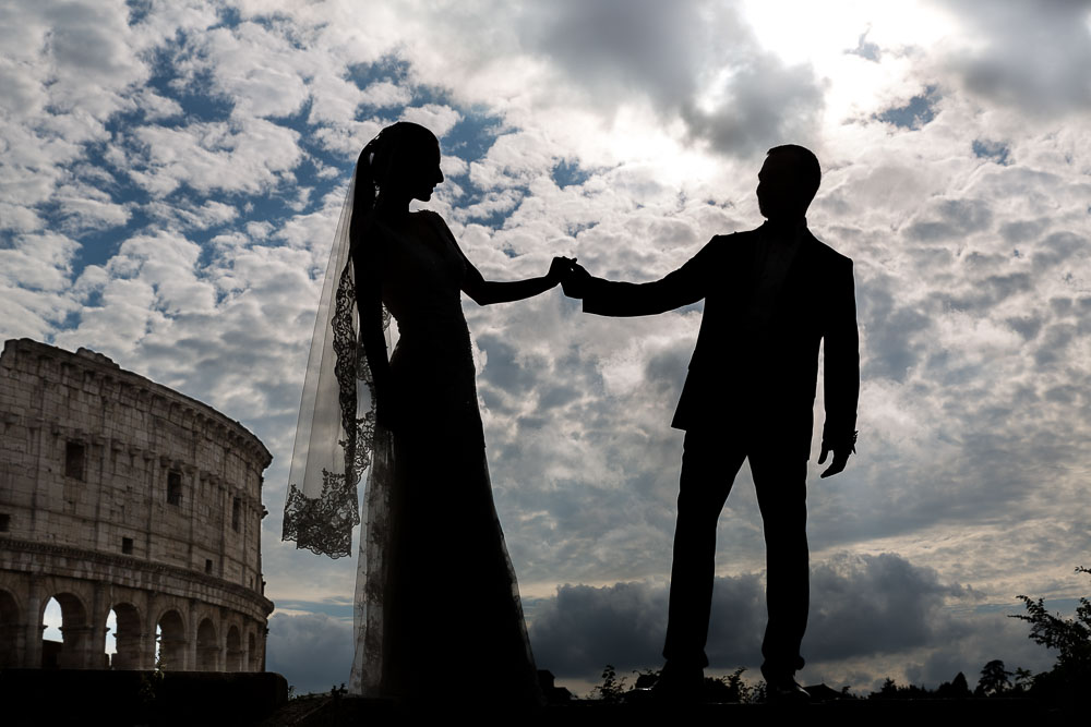 Holding hand in hand silhouette at the Roman Colosseum