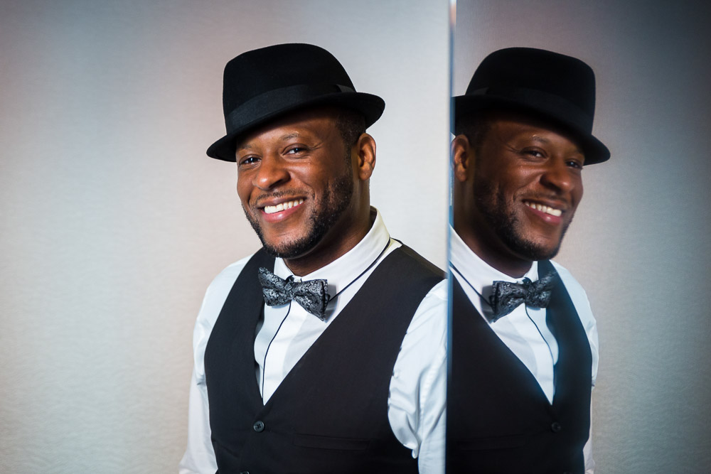 Male portrait with hat and seen through the mirror