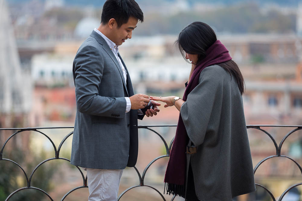 Putting on the wedding engagement ring on the hand