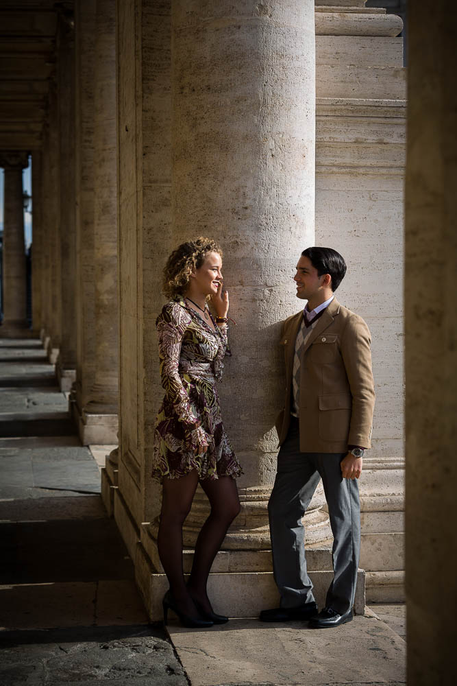 couple talking while standing underneath ancient columns