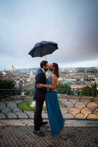 Couple holding an umbrella at Parco del Pincio during a rainy day in Rome