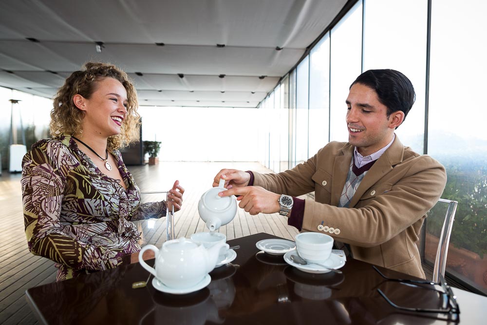 Couple having tea together. Man pouring into a cup