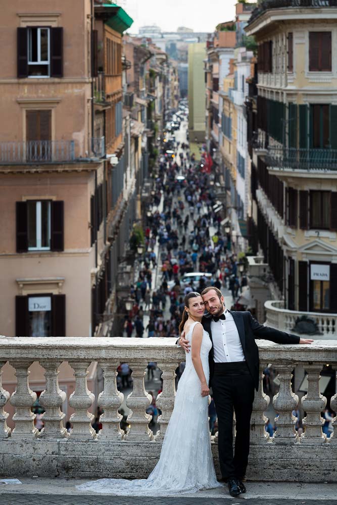 Portrait image of newlywed couple on the terrace of Trinita' dei Monti