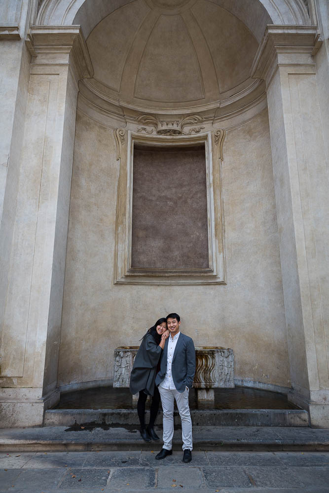 Portrait picture of a couple posing by a water fountain