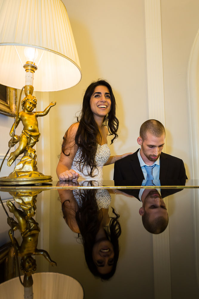 Bride and groom playing the piano together