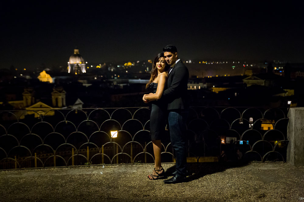 Eengagement session taking place on a terrace overlooking the roman skyline later evening 