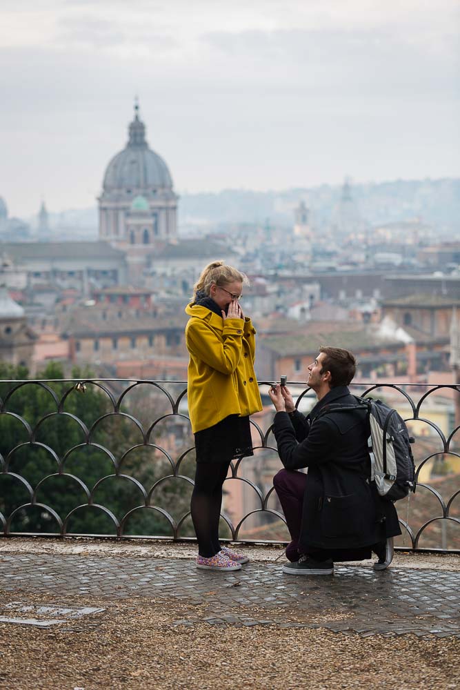 Man proposing at a Park in the city of Rome before the sweeping view. Marriage Proposal Photos.