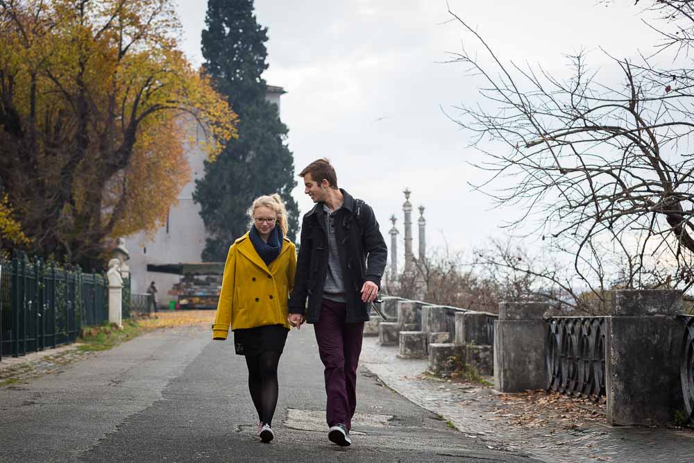 Walking hand in hand together during an e-session in the city of Rome Italy