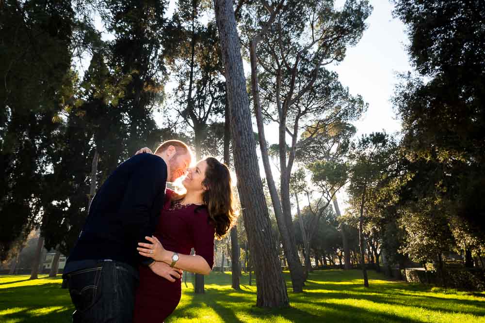 Couple kissing in a park at sunset