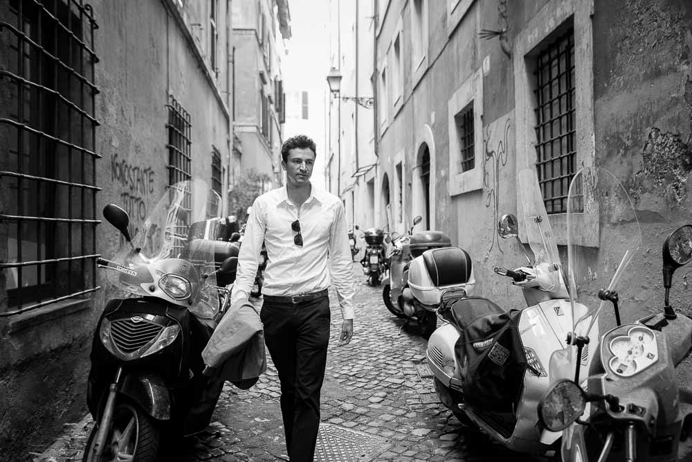 Walking in a roman alleyway among scooters and black and white photography