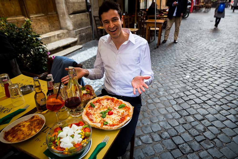 Man eating an Italian pizza in the streets of Rome