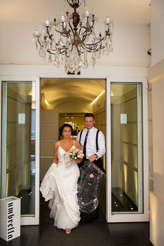 Bride and groom exiting the hotel