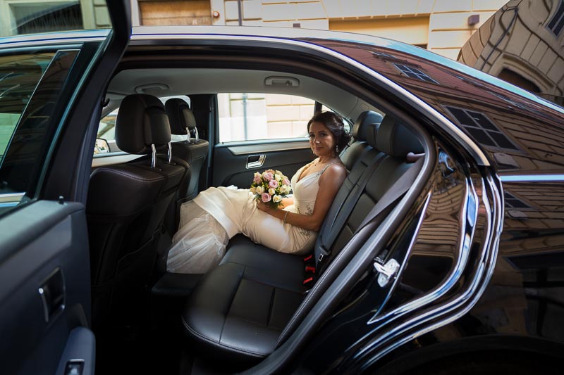 Bride sitting the wedding car