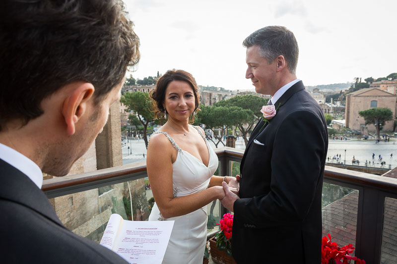 Wedding celebrant reciting the promises overlooking the city. On a Wedding Day in Rome.