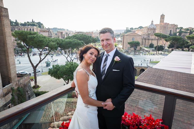 Groom and bride portrait overlooking the city of Rome after their private marriage