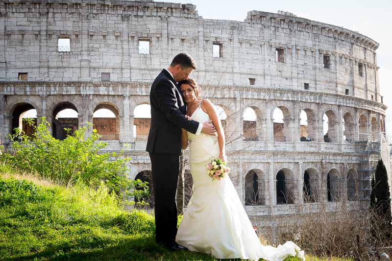 Newlyweds getting their picture taken at the Coliseum in Rome