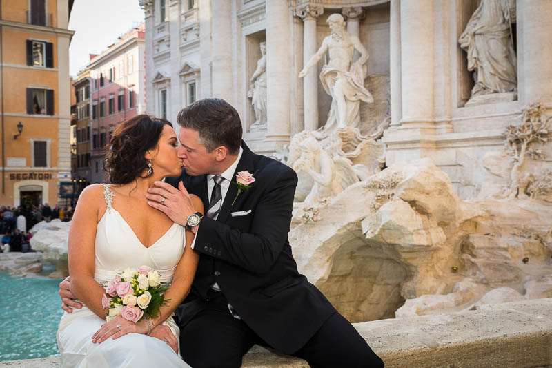 Kissing at the Trevi fountain in Rome during a wedding