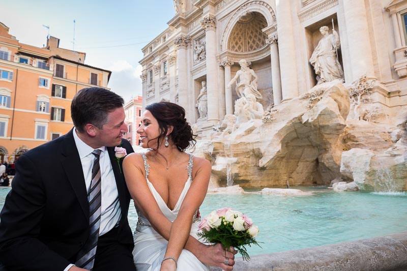 Newlyweds kissing at the Trevi fountain