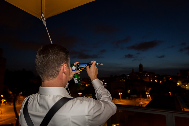 Man taking a picture of the ancient city at night