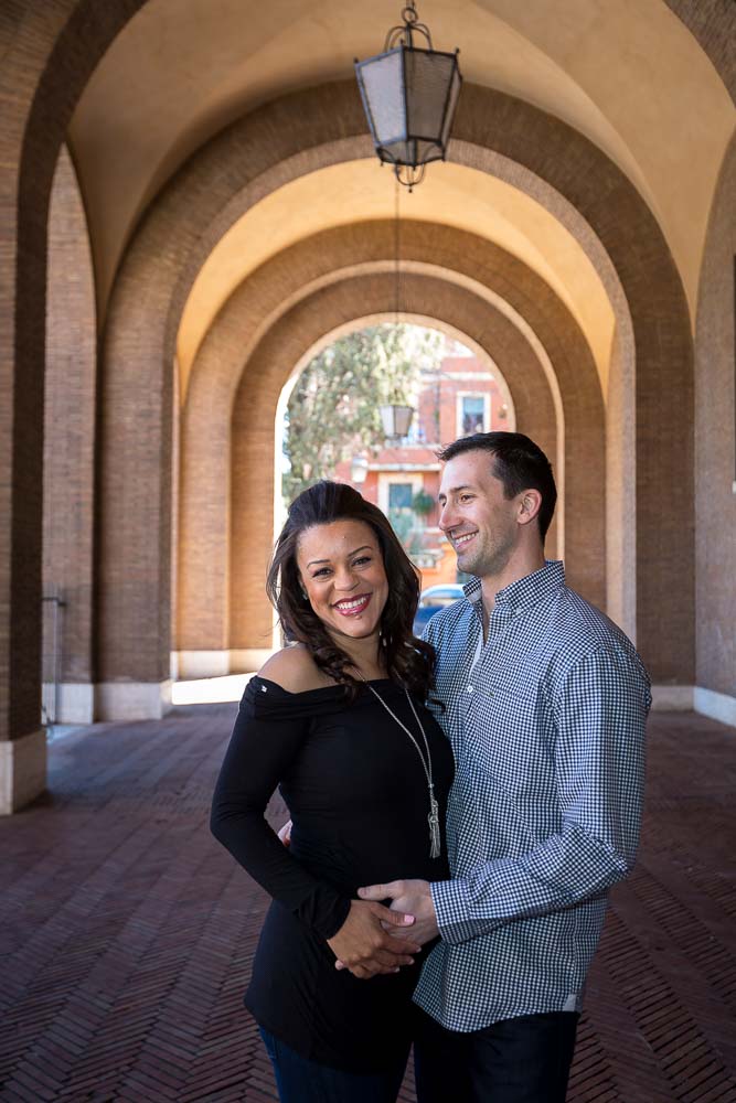 Up close picture of a couple together under the portico of a church