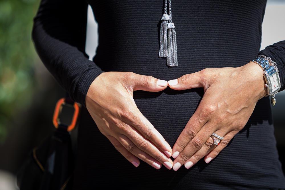 Close up image of hands over belly in pre natal photo shoot
