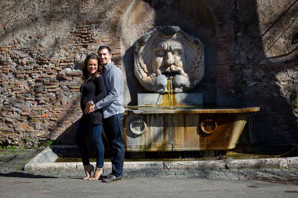 Couple posing in front of a water fountain