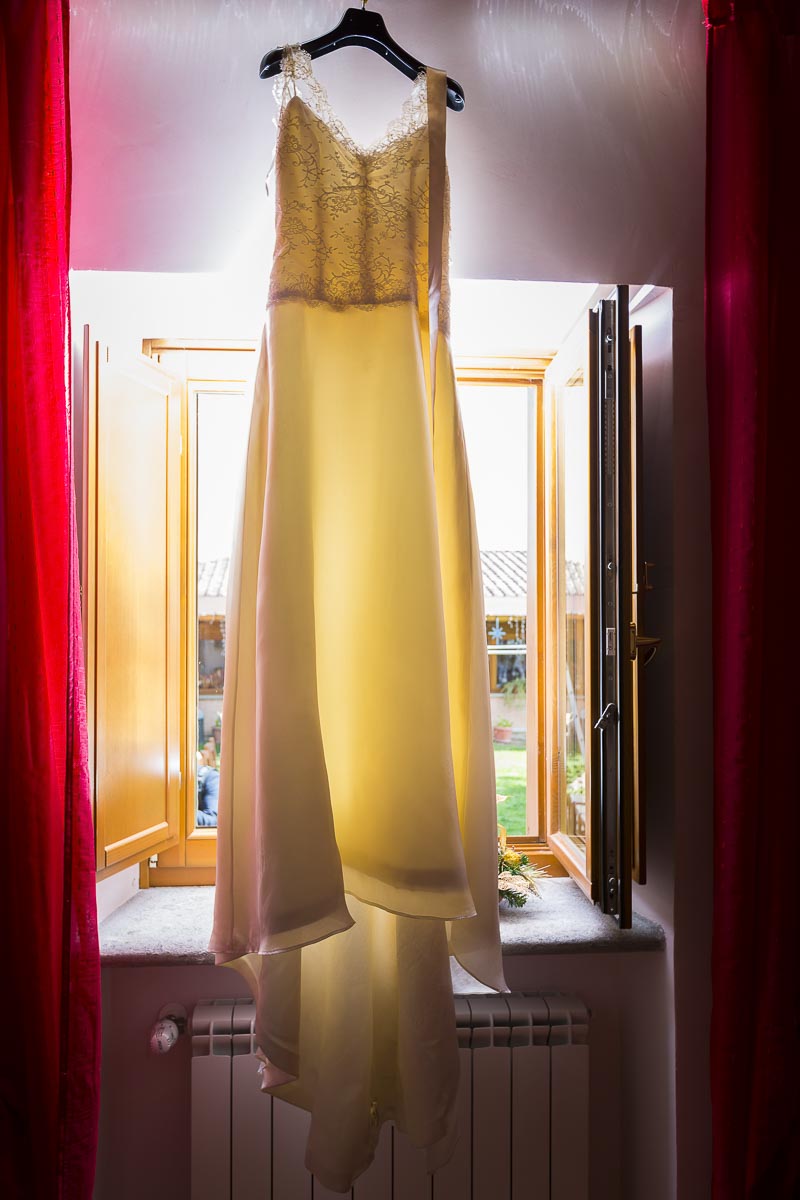 Hanging wedding dress by the light window