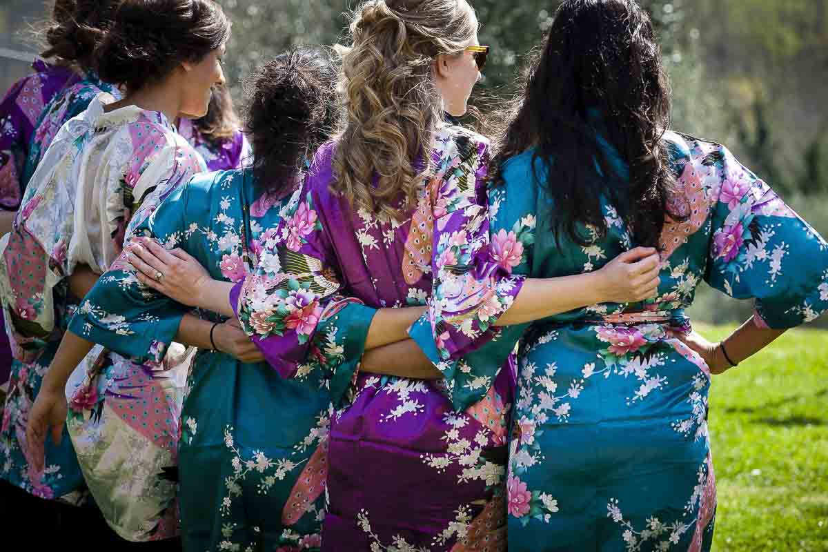 Bridesmaids wearing robes photo from behind