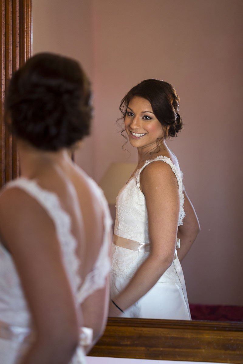 The bride looking in the mirror when ready