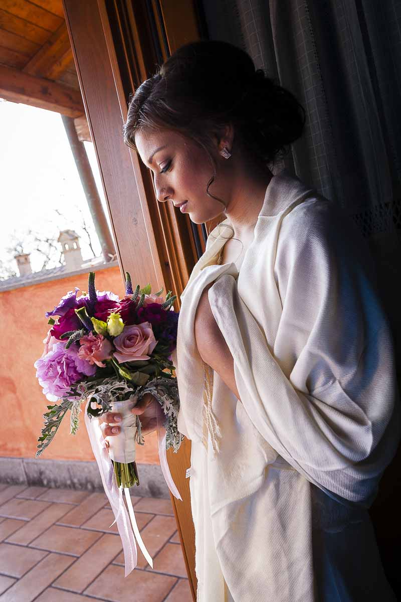 Photo of the bride by the door with light
