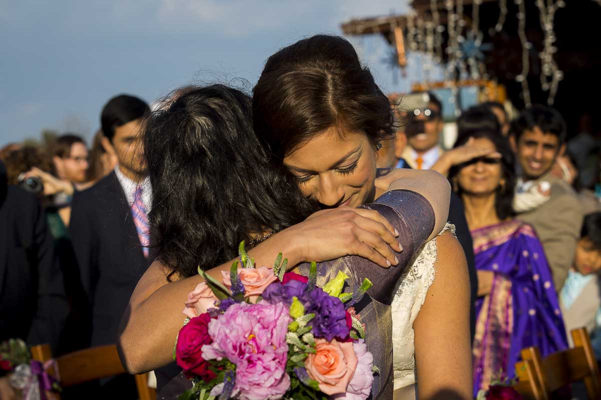 Bride hugging mom before the marriage ceremony