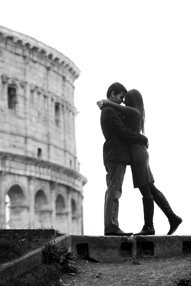 Black and white image of a couple photographed at the Colosseum in Rome Italy