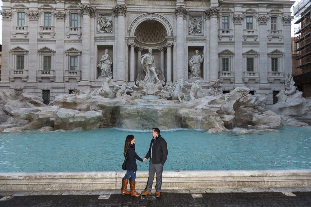 Couple standing at the Trevi fountain