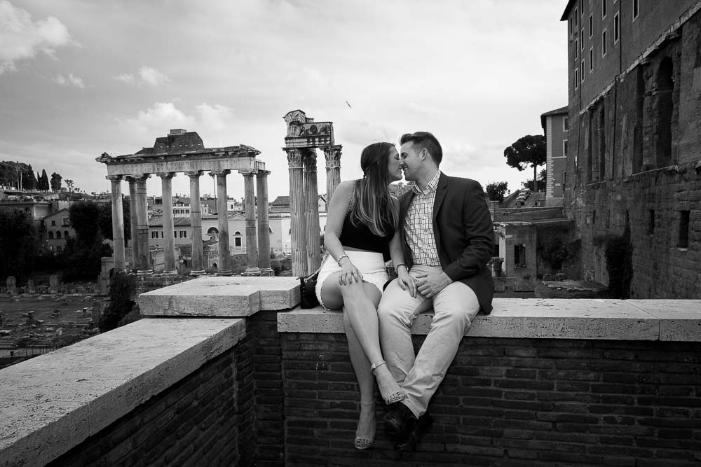 Kissing at the Roman Colosseum in Rome Italy. B&w view