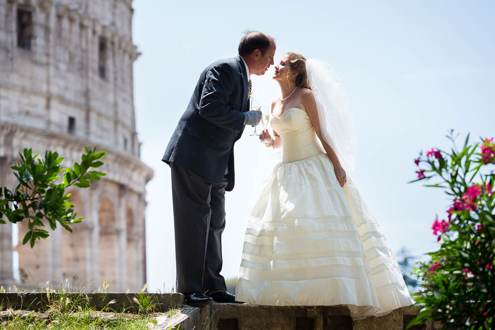 Wedding couple romantically kissing at the Roman Colosseum