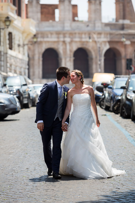 Bride and groom walking together in the streets and alleyways of Rome