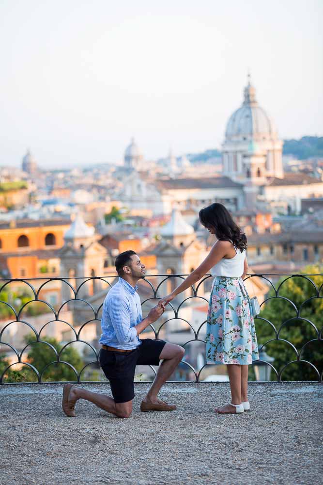 Man knee down Surprise Rome Proposal photography at Parco del Pincio in Rome Italy