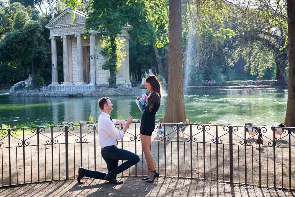 Man asking the big question. Proposing in Rome at the small lake of Villa Borghese in Rome Italy